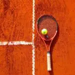 tennis racquet on clay court