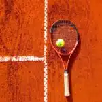 tennis racquet on clay court