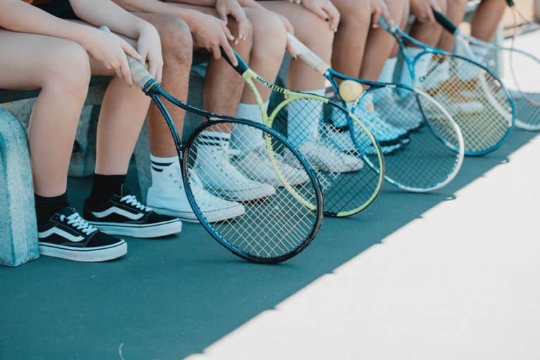 players wearing shoes on tennis court