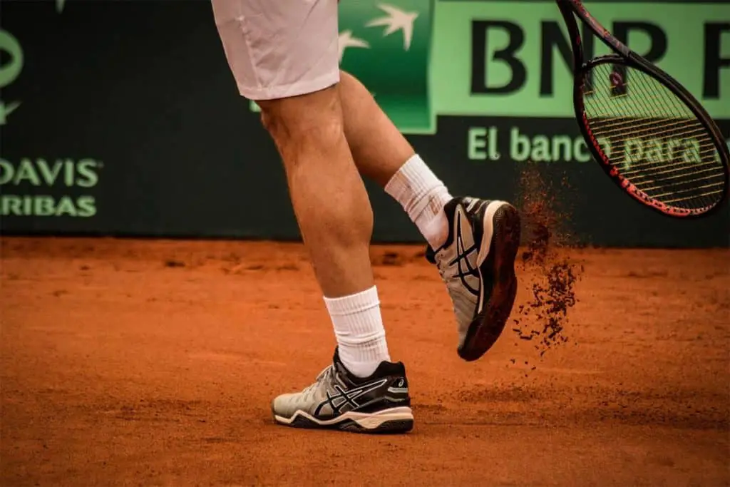 tennis shoes on clay court