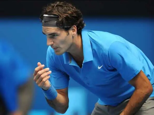 Roger Federer blowing on his fingers